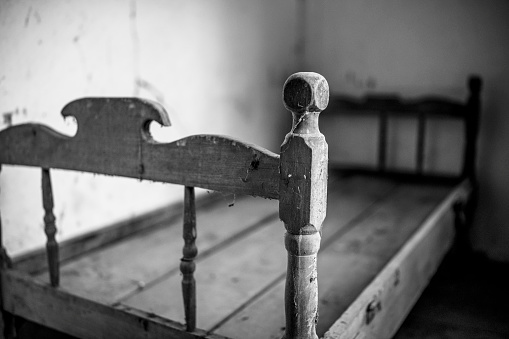 Close-up shot of a bed frame in an old abandon windmill.