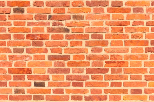istock A wall of old, cracked bricks, with a weathered and faded surface. 1306309110