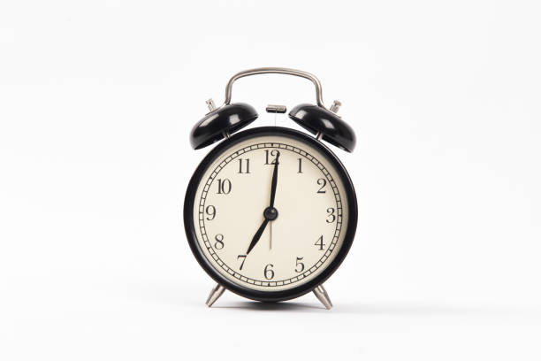 istock Black retro alarm clock isolated on white background 1306309163
