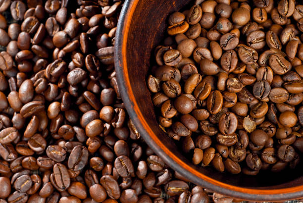 istock Coffee beans close up. Coffee in a clay bowl. 1306310790