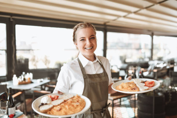 istock Female Waitress Bringing Over Fresh Omelette In Restaurant 1306312479