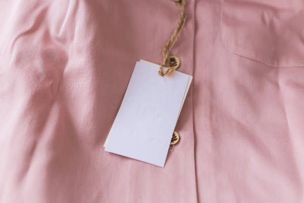 istock Close-up blank tag label on pink shirt. Copy space. space for advertisement. 1306312536