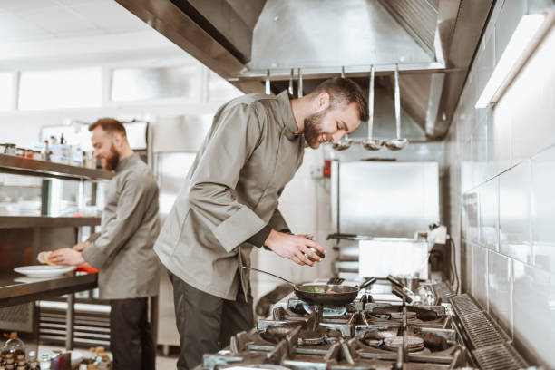 istock Male Cooks Enjoying Their Job And Competing While Working 1306312564