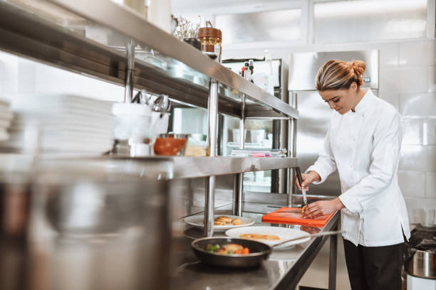 istock Modern Female Cook Preparing Dinner For The Whole Restaurant 1306312644