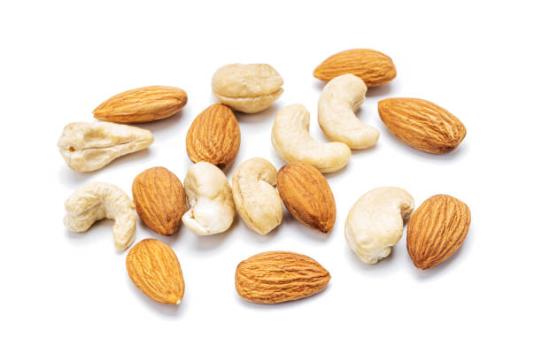istock cashew and almond nuts isolated on white background. nuts variation cut out 1306312724