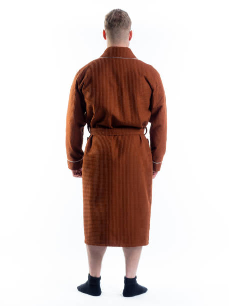 istock man in a Bathrobe from the back on an isolated white background. 1306314390