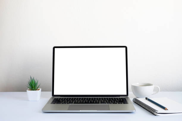 istock White office desk table with keyboard of laptop, coffee cup and notebook, mouse computer with equipment office supplies. Business and finance concept. Workplace, Flat lay with blank copy space. 1306314894