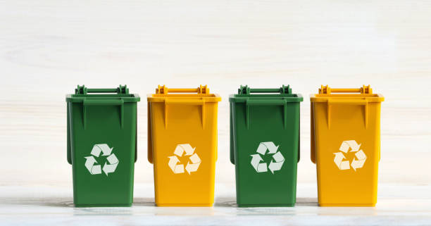 istock Four plastic dumpsters, yellow and green, with open lids, the ecology icon, on a white insulated background. The concept of caring for the environment, sorting garbage, household waste for recycling 1306315907