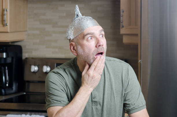 istock Man with aluminum foil hat 1306317880