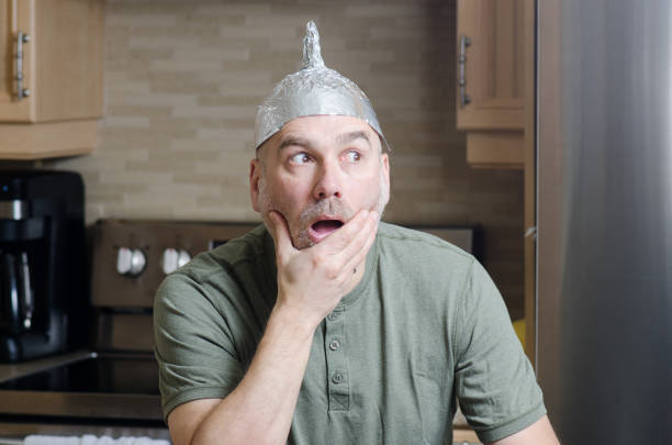 istock Man with aluminum foil hat 1306317951
