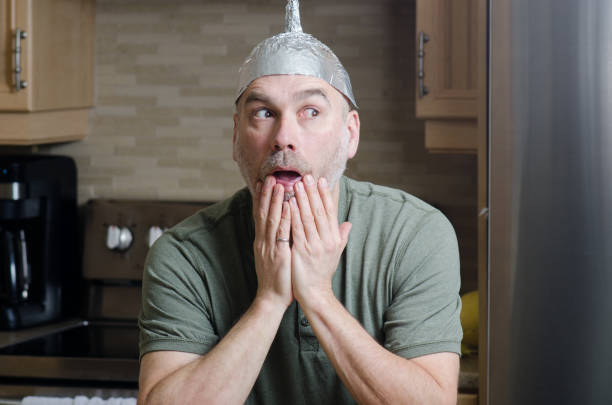 istock Man with aluminum foil hat 1306317995