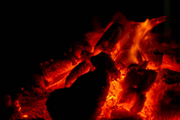 Incandescent charcoal ember in orange and yellow tones. Heat concept