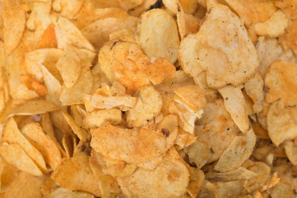 istock Crispy potato chips snack texture background. Group of chips 1306321121