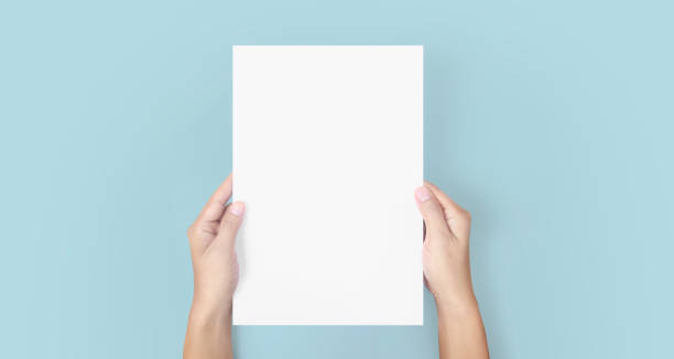istock Hands holding paper blank for letter paper 1306321558