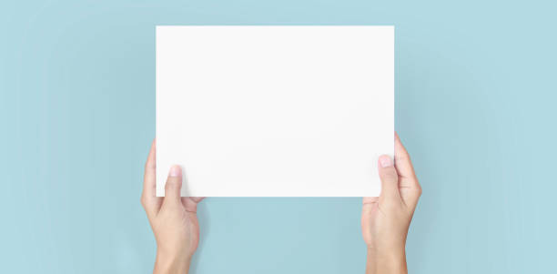 istock Hands holding paper blank for letter paper 1306321559