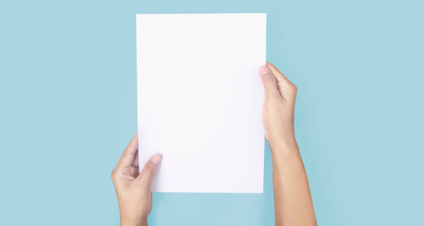 istock Hands holding paper blank for letter paper 1306321560