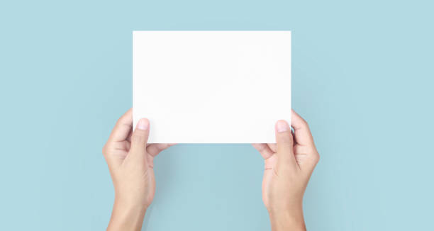 istock Hands holding paper blank for letter paper 1306321564
