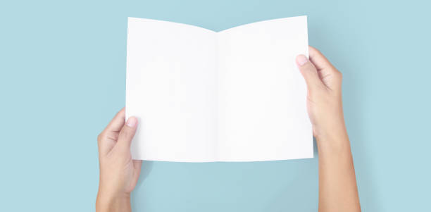 istock Hands holding paper blank for letter paper 1306321569
