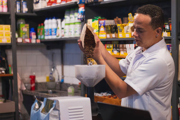 istock Man in his small grocery store. 1306321607