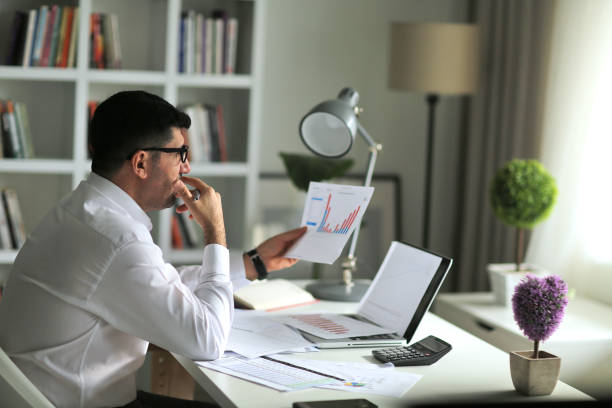 istock Thoughtful businessman  analyzing sales data and economic growth graph chart. Business strategy 1306322664