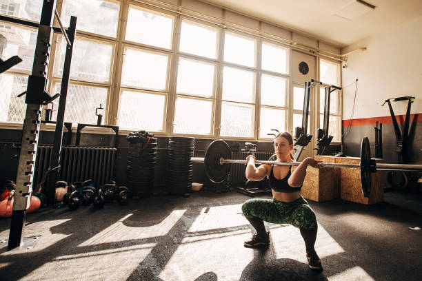 istock Woman training with weights in gym 1306326086