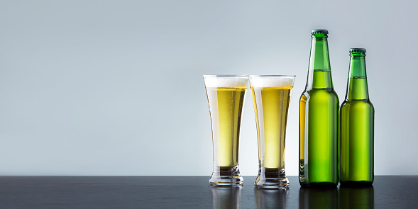 Two Glass Of Beer With Bottles On Wooden Counter With Place For Text. Banner. Non Alcoholic Drink Concept.