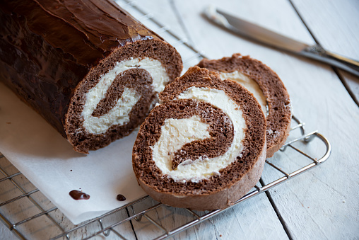 Sweet roll with wiped cream, delicious homemade chocolate cake