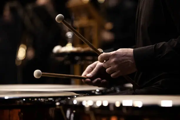 Photo of Hands of a musician playing the timpani