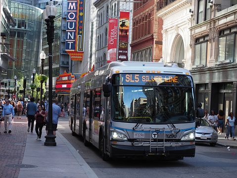 Boston, USA - June 15, 2019: Bus of the Massachusetts Bay Transportation Authority driving around in downtown Boston.