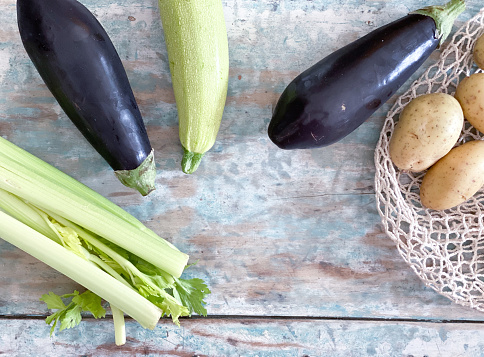 Food background with vegetables: celery, zucchini,  eggplant and potatoes