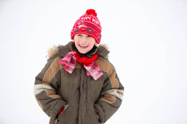 Child in winter. Cheerful boy in winter clothes smiles. Child in winter. Cheerful boy in winter clothes smiles. kids winter coat stock pictures, royalty-free photos & images