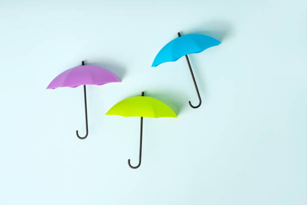 istock Colored umbrellas on a blue background. Conceptuality and place for the text 1306335268