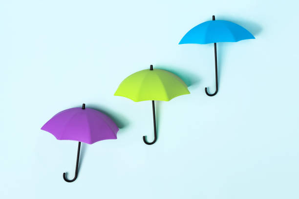 istock Colored umbrellas on a blue background. Conceptuality and place for the text 1306335292