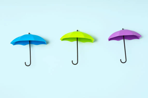 istock Colored umbrellas on a blue background. Conceptuality and place for the text 1306335301