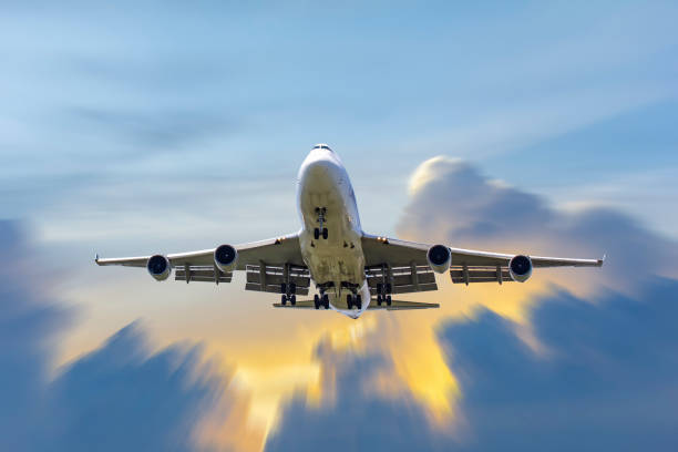 istock front image commercial passenger aircraft or cargo transportation airplane fly to sky with sunshine and cloudy (background effect motion blur) 1306335649