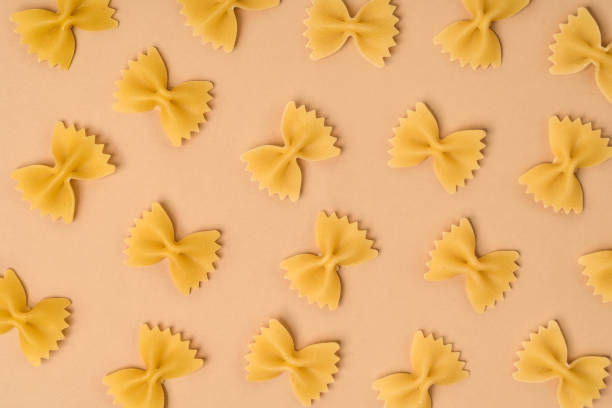 istock A pattern from the post of the type of bows (farfalle) on a beige background, a place for the text 1306336482