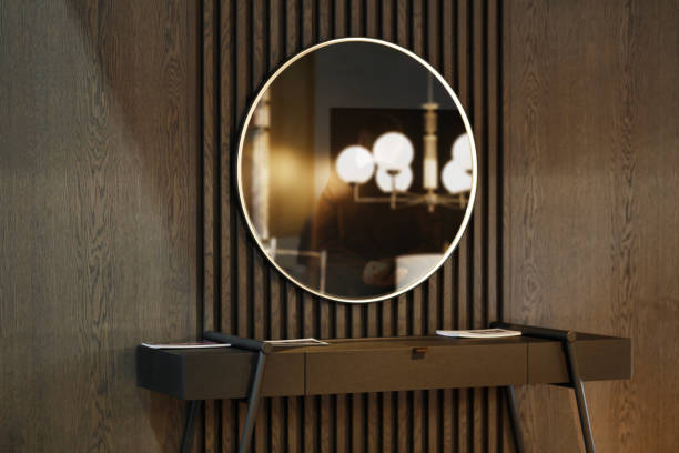 Stylish trendy dark brown wooden interior decorated with huge round mirror. Dark brown trendy interior pieces. dresser domestic room entrance hall home interior stock pictures, royalty-free photos & images
