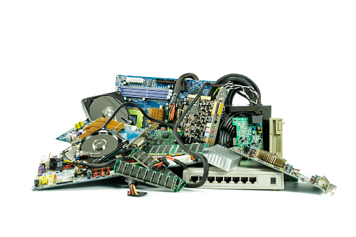 a heap of electronic and computer hardware waste for disposal or recycling - junked computer parts
