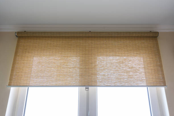 Roller blinds made of thin bamboo on the window