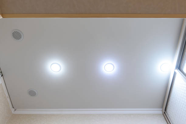 istock Stretch white matte ceiling in the hallway, ventilation grilles and spotlights are installed in the ceiling 1306337209
