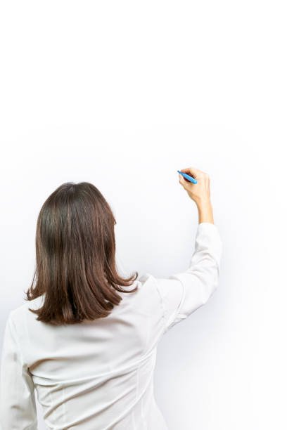 istock Woman writing on white background with blue marker pen. Concept background, 1306337367