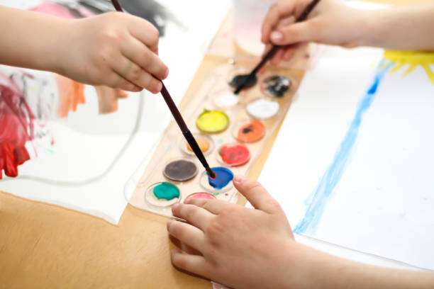 istock kids hand and paintbrush 1306338658