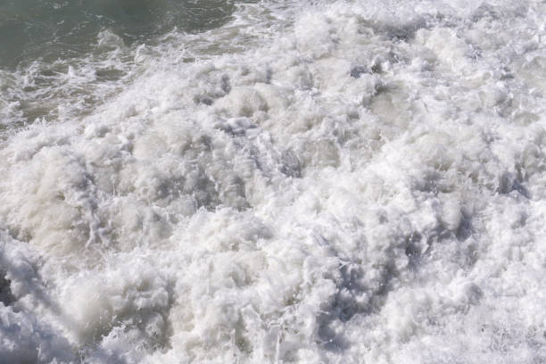 istock Big waves at open sea. Summer monsoon. White crest of a sea wave. texture background 1306338923
