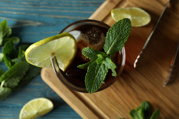istock Board with glass of Cuba Libre on wooden table 1306340101