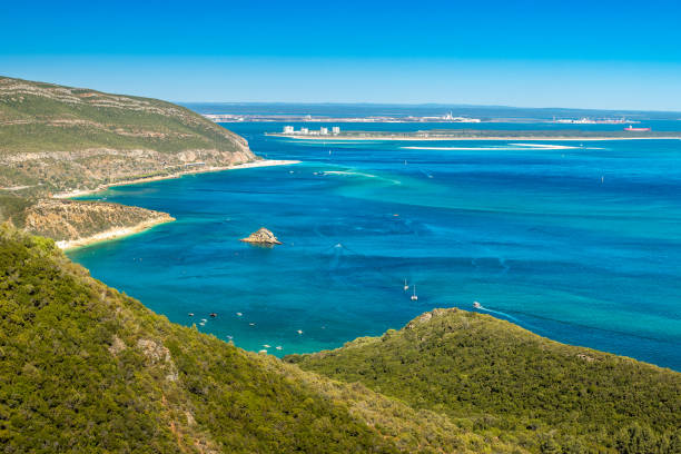 Beautiful landscape of the Arrábida Natural Park in Portugal, with the mountains, beaches, blue sea and in the background the Troia peninsula on a sunny day in summer. stock photo