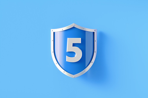 Silver shield with number 5 sitting on blue background, Horizontal composition with copy space. Security, safety and privacy concept.