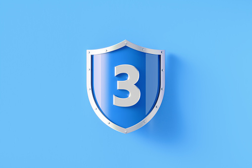 Silver shield with number 3 sitting on blue background, Horizontal composition with copy space. Security, safety and privacy concept.