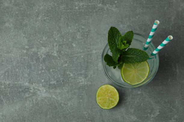 istock Glass of mojito cocktail on gray table 1306341869