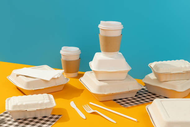 istock Lunchboxes, cutlery and drinks on orange table. Food delivery concept 1306341933
