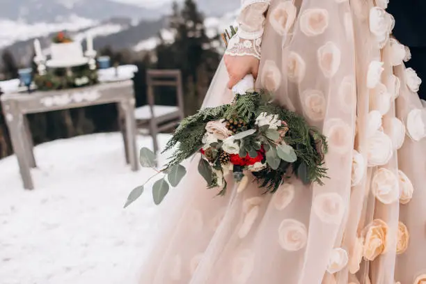 Photo of Beautiful winter bouquet in the hands of the bride